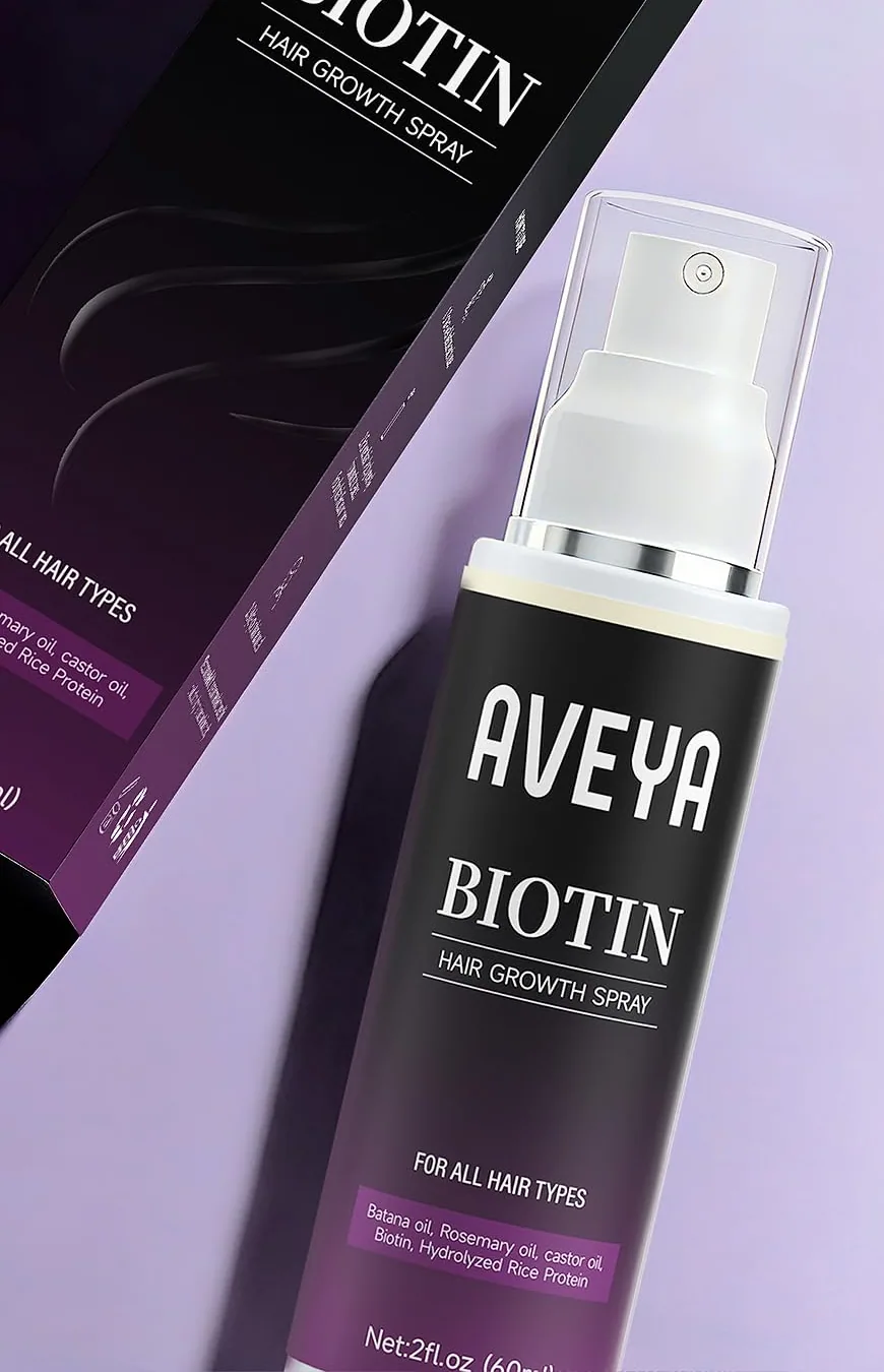AVEYA Biotin Hair Growth Spray bottle lying across its box